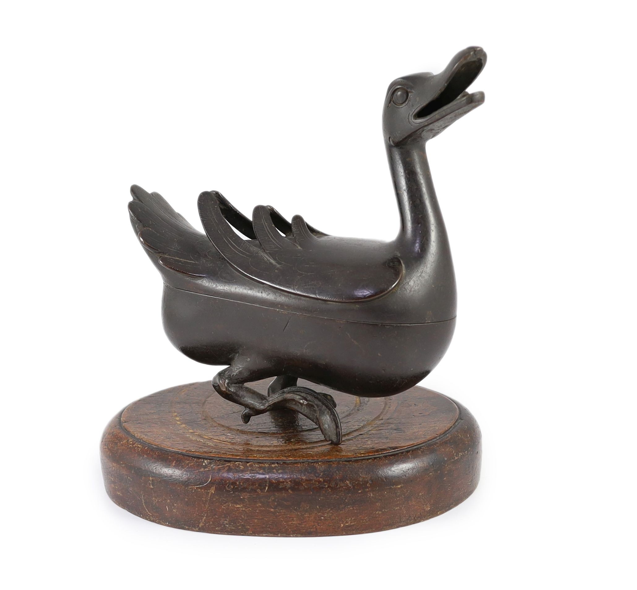 A Chinese Ming bronze ‘duck’ censer and cover, 17th century, 24.5cm long, missing one foot and later inset wood stand